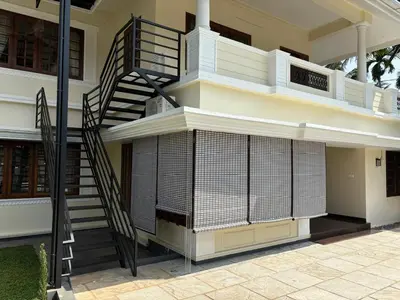 a staircase on the side of a house at Serene Nest Apartment-Kochi Airport in Nedumbassery