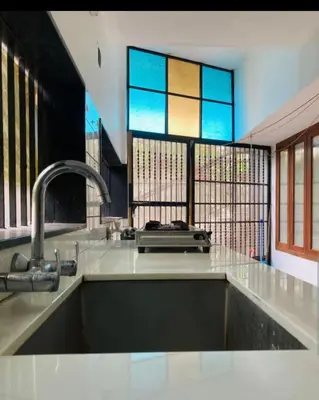 a kitchen with a sink and a stained glass window at LINE Villas in Kodungallūr