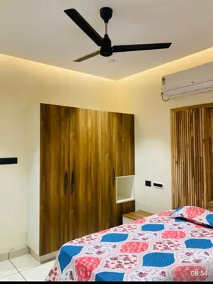 a bedroom with a bed with a ceiling fan at LINE Villas in Kodungallūr