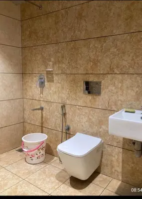 a bathroom with a toilet and a sink at LINE Villas in Kodungallūr