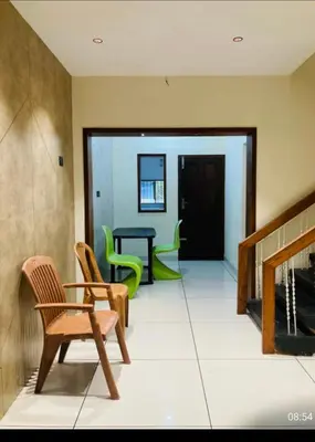 a living room with chairs and a fireplace at LINE Villas in Kodungallūr