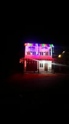 a building with christmas lights on it at night at Portico Resorts in Pandalūr