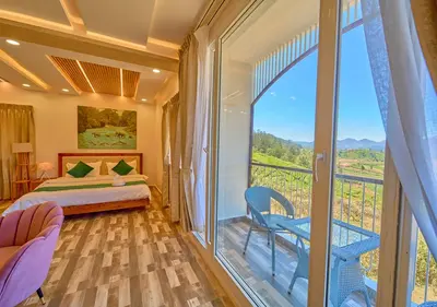 a bedroom with a bed and a balcony with a view at Vihani's Western Clouds Ooty by VOYE HOMES - Peaceful Getaway Near Avalanche Emerald Lake in Ooty