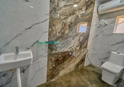 a bathroom with a sink and a toilet at Vihani's Western Clouds Ooty by VOYE HOMES - Peaceful Getaway Near Avalanche Emerald Lake in Ooty
