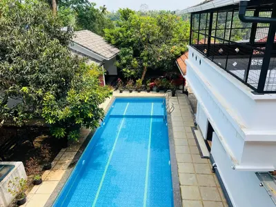an overhead view of a swimming pool next to a building at 3 Empire One Bedroom with Common Pool in Wayanad