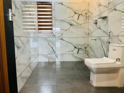 a bathroom with a toilet and a shower at 3 Empire One Bedroom with Common Pool in Wayanad