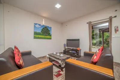 a living room with two couches and a television at Onella in Yedapalli