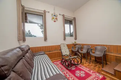a living room with a couch and a table and chairs at Onella in Yedapalli