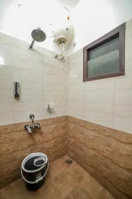 a bathroom with a shower with a fan and a sink at Interlaken in Yedapalli