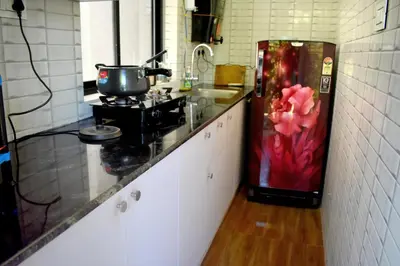 a kitchen with a red refrigerator in a kitchen at Green Heaven Kuruva Wayanad in Chekadi