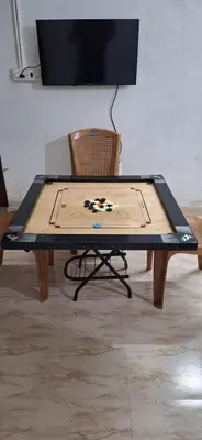 a ping pong table with a game board on it at Holiday Apartments & Homestay in Sultan Bathery