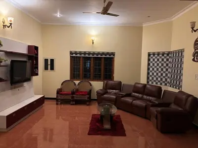 a living room with leather furniture and a flat screen tv at 