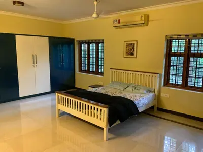 a bedroom with a bed in a room with yellow walls at 