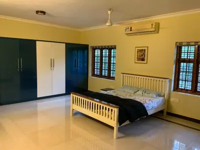 a bedroom with a bed in a room with yellow walls at 