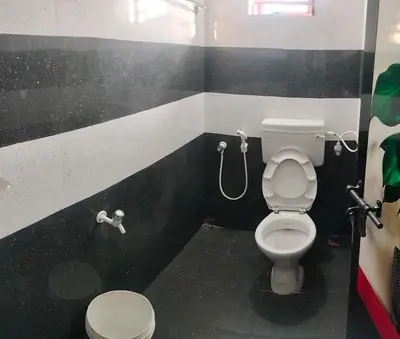 a bathroom with a toilet and a shower at Aswathy Bhavan in Palakkad
