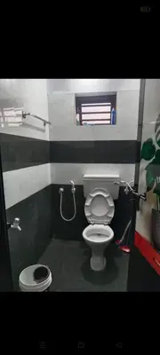 a small bathroom with a toilet and a shower at Aswathy Bhavan in Palakkad