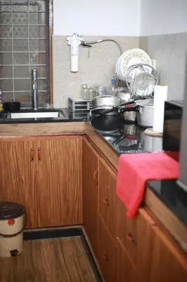 a kitchen with a stove and a red towel at Dreams Valley in Kadavoor