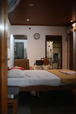 a bedroom with a bed and a clock on the wall at Dreams Valley in Kadavoor