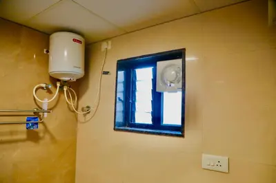 a window in a bathroom with a shower at Virksham Hotel in Coimbatore