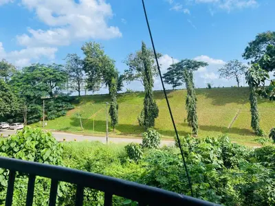 a view of a hill with trees and a road at Laura Airport Suits & Apartments in Nedumbassery