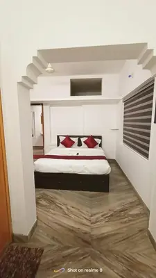 a bedroom with a large bed with red pillows at calicut residency in Kozhikode