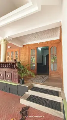 a room with a door and a pair of shoes at calicut residency in Kozhikode