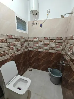 a bathroom with a toilet and a sink at Jazz&Hill in Kodaikānāl