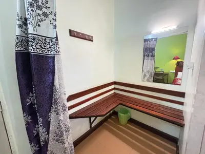 a room with a wooden bench and a mirror at Hotel SilverLine Regency Munnar in Munnar