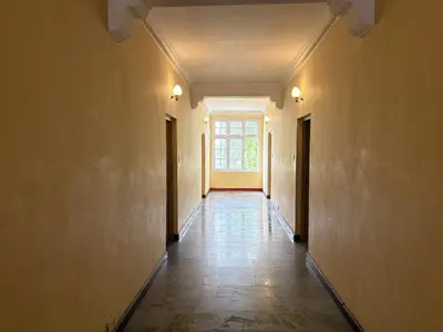 an empty hallway with a window in a building at Hotel SilverLine Regency Munnar in Munnar