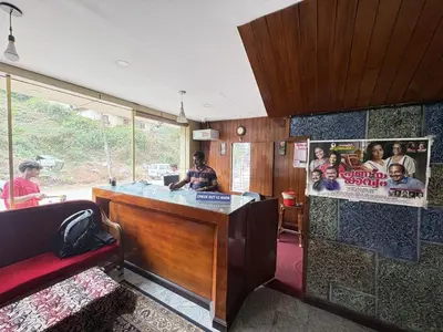 a bar in a room with people sitting around it at Hotel SilverLine Regency Munnar in Munnar