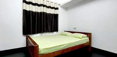 a small bed in a room with a window at Diya Homestay Mamalakandam in Mamalakandam