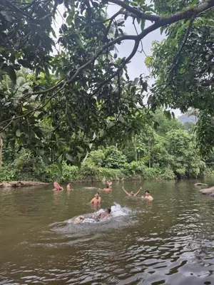 a group of people swimming in a river at Diya Homestay Mamalakandam in Mamalakandam