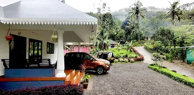 a car parked outside of a small house at Diya Homestay Mamalakandam in Mamalakandam