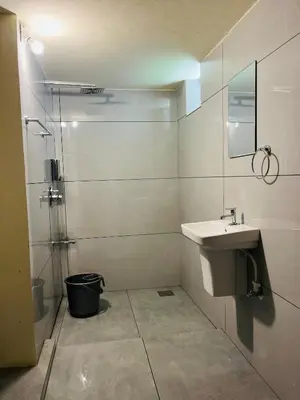a bathroom with a sink and a shower at Pragathi Homestay in Mananthavady
