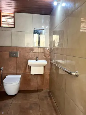 a bathroom with a sink and a toilet at Pragathi Homestay in Mananthavady