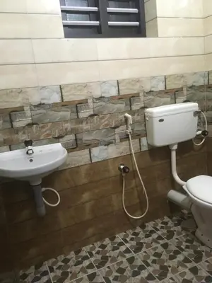 a bathroom with a toilet and a sink at Peaceful perch in Kozhikode