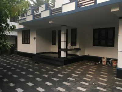 a house with a courtyard in front of it at Peaceful perch in Kozhikode