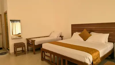a bedroom with a bed and a chair in it at Banana Tree Retreat in Kodaikānāl
