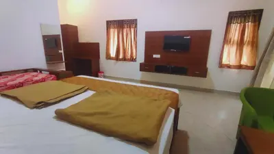 a bedroom with a bed and a tv in it at Banana Tree Retreat in Kodaikānāl
