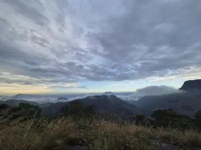 a view of a mountain range with clouds in the sky at Mamalakandam - The White house, Diya homestay in Mamalakandam