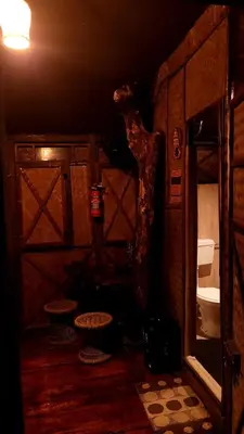 a dark room with a bathroom with a toilet at Greens Tree House & Wood House in Sultan Bathery