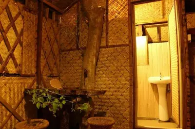 a bathroom with a toilet and a sink at Greens Tree House & Wood House in Sultan Bathery