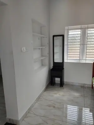 a white room with a mirror on the wall at Jeevakanthan Home Stay in Alāndurai