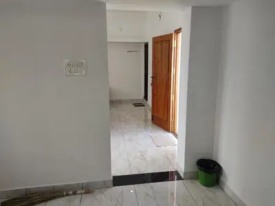 an empty room with a door and a tile floor at Jeevakanthan Home Stay in Alāndurai