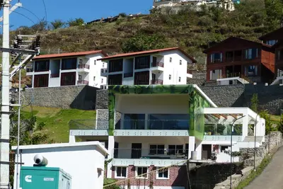 a building on the side of a hill at GReaT Trails Kodaikanal by GRT Hotels in Kodaikānāl