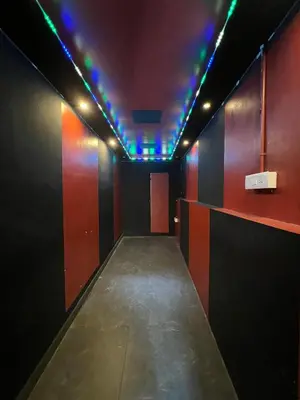 an empty corridor with colored lights in a room at Kosher Livings Holiday in Kalpetta