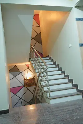 a staircase in a building with a colorful tile floor at Athira Residency Coorg in Kushālnagar