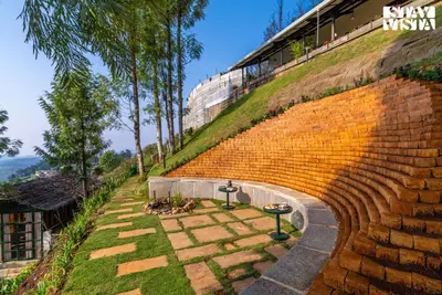 a brick amphitheater with a building on top of a hill at StayVista at Under the Stars Lovedale ooty in Ooty