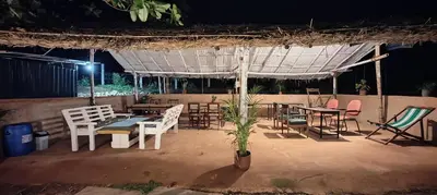 a group of tables and chairs under a tent at Moonrise Kingdom Permaculture Farm Stay in Hura