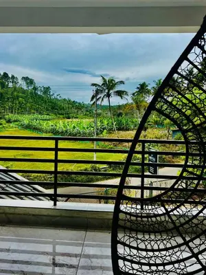 a metal bench sitting on top of a balcony at Sands Villa Homestay in Wayanad